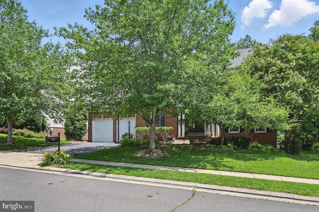 4788 Charter Ct, Woodbridge, VA 22192 - obstructed view of property featuring asphalt driveway, a front lawn, and brick siding