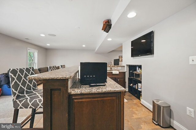 4788 Charter Ct, Woodbridge, VA 22192 - kitchen featuring a kitchen breakfast bar, dark brown cabinetry, recessed lighting, light stone counters, and open floor plan