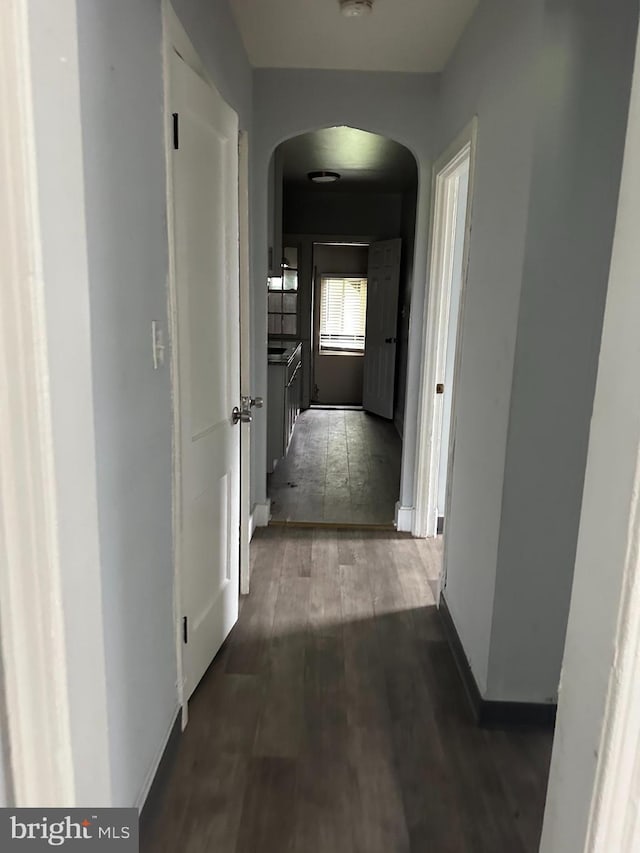 248 Hamilton NW, Washington, DC 20011 - hallway featuring arched walkways, wood finished floors, and baseboards