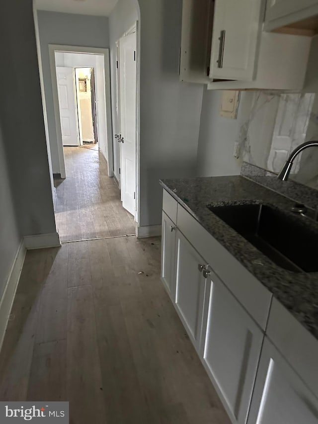 248 Hamilton NW, Washington, DC 20011 - kitchen featuring a sink, baseboards, white cabinetry, and light wood finished floors