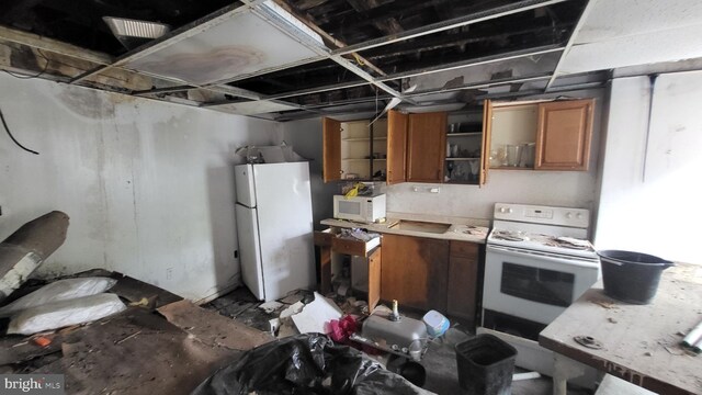 3224 W York St, Philadelphia, PA 19132 - kitchen featuring white appliances, brown cabinetry, and light countertops
