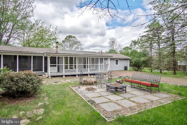 109 Knob Ct, Albrightsville, PA 18210 - back of house featuring an outdoor fire pit, a sunroom, a lawn, a patio, and a shingled roof