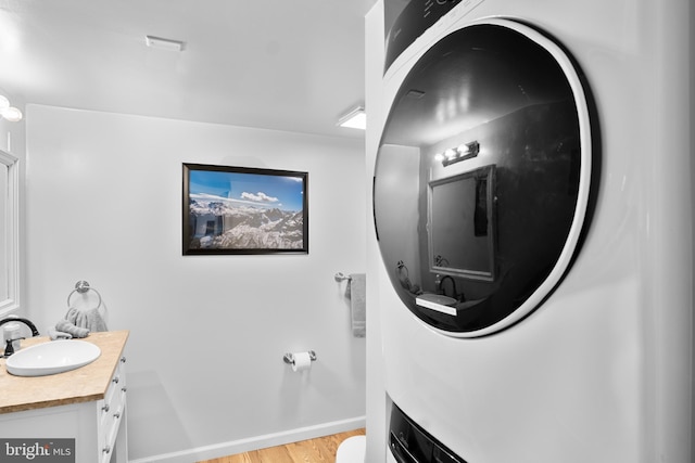 109 Knob Ct, Albrightsville, PA 18210 - laundry room with a sink, stacked washer and clothes dryer, and light wood-type flooring