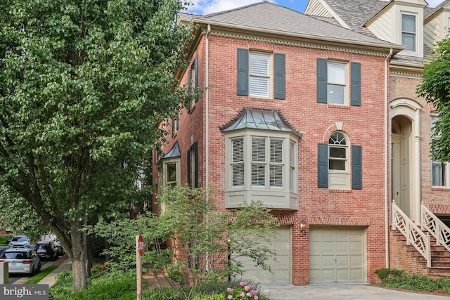 6638 Hampton View Pl, Mclean, VA 22101 - view of front of house featuring driveway, brick siding, and a garage