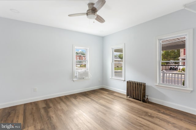 213 Franklin St, Hightstown, NJ 08520 - spare room with radiator, baseboards, wood finished floors, and ceiling fan
