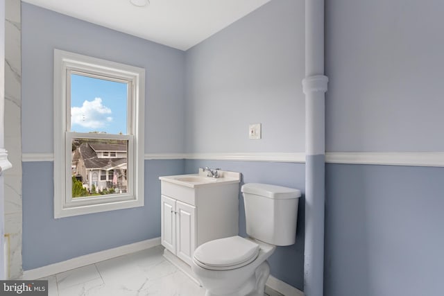 213 Franklin St, Hightstown, NJ 08520 - bathroom with toilet, vanity, marble look tiles, and baseboards