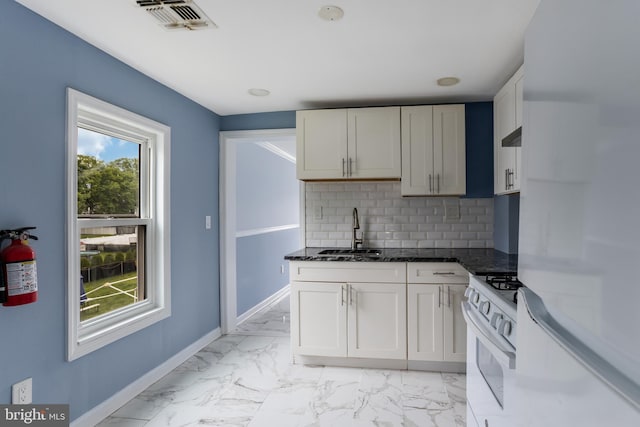 213 Franklin St, Hightstown, NJ 08520 - kitchen featuring a sink, white range with gas stovetop, freestanding refrigerator, light marble finish flooring, and decorative backsplash