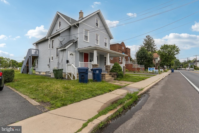 213 Franklin St, Hightstown, NJ 08520 - view of front of house featuring a porch, a chimney, and a front lawn