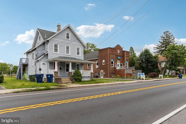 213 Franklin St, Hightstown, NJ 08520 - view of front facade featuring covered porch and a chimney
