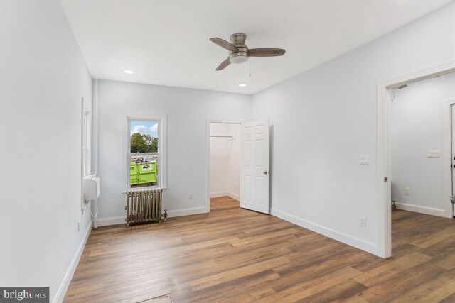 213 Franklin St, Hightstown, NJ 08520 - unfurnished bedroom with radiator, wood finished floors, baseboards, a walk in closet, and recessed lighting