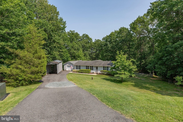3 Cove Ct, Stafford, VA 22554 - single story home with driveway, a front yard, a garage, and a view of trees