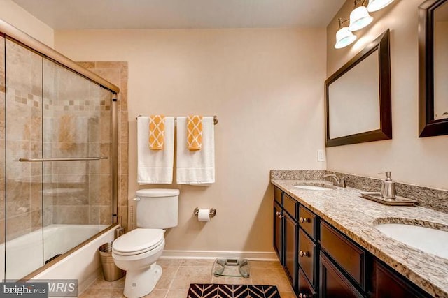 608 S Washington St, Baltimore, MD 21231 - full bath featuring toilet, tile patterned flooring, double vanity, shower / bath combination with glass door, and baseboards
