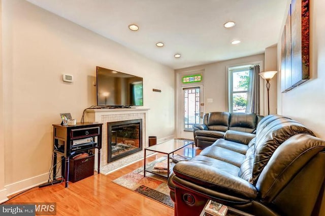 608 S Washington St, Baltimore, MD 21231 - living room featuring a tile fireplace, wood finished floors, recessed lighting, and baseboards