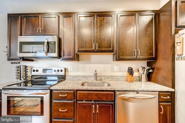 608 S Washington St, Baltimore, MD 21231 - kitchen featuring stainless steel appliances, a sink, and light stone countertops