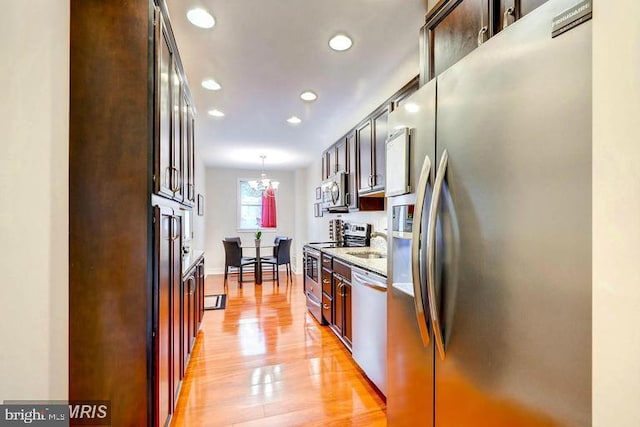 608 S Washington St, Baltimore, MD 21231 - kitchen with stainless steel appliances, light wood-style flooring, recessed lighting, a chandelier, and decorative light fixtures