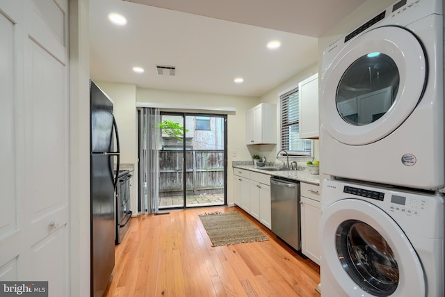 106 W Montgomery St, Baltimore, MD 21230 - washroom featuring estacked washer and dryer, light wood-style floors, and recessed lighting