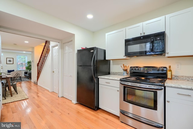 106 W Montgomery St, Baltimore, MD 21230 - kitchen featuring black appliances, light wood finished floors, recessed lighting, and light stone countertops