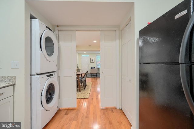 106 W Montgomery St, Baltimore, MD 21230 - laundry room featuring stacked washer / drying machine and light wood-style floors