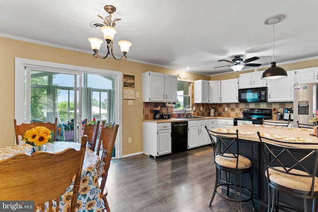404 Clover Rd, Etters, PA 17319 - kitchen with black appliances, light countertops, a sink, white cabinetry, and tasteful backsplash