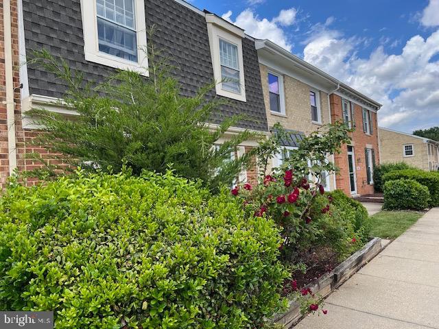 9075 N Laurel Rd Unit J, Laurel, MD 20723 - view of side of property with mansard roof, a shingled roof, and brick siding