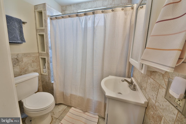 452 Fitzgerald St, Philadelphia, PA 19148 - bathroom with tile walls, vanity, a wainscoted wall, shower / tub combo with curtain, and tile patterned floors