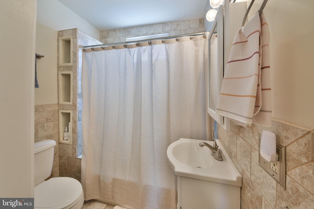 452 Fitzgerald St, Philadelphia, PA 19148 - full bathroom featuring tile walls, vanity, shower / tub combo, and wainscoting