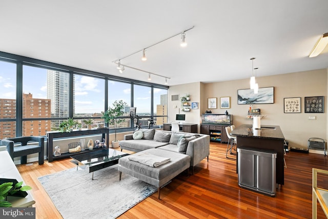 2101 Market St Unit 1104, Philadelphia, PA 19103 - living room with a view of city, wood finished floors, and rail lighting