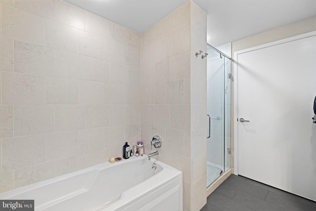 2101 Market St Unit 1104, Philadelphia, PA 19103 - full bath with a shower stall, a bath, tile patterned flooring, and tile walls