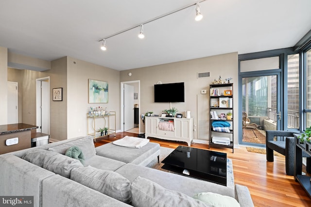 2101 Market St Unit 1104, Philadelphia, PA 19103 - living room with rail lighting and light wood-style floors