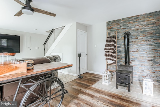 726 Harmony Orchard Rd, Front Royal, VA 22630 - kitchen featuring wood finished floors, a ceiling fan, a wood stove, and baseboards