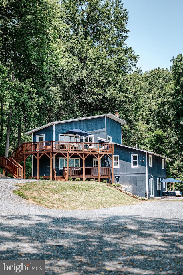 726 Harmony Orchard Rd, Front Royal, VA 22630 - rustic home featuring a deck, a chimney, stairway, driveway, and a forest view