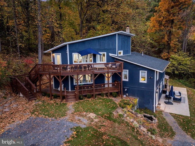 726 Harmony Orchard Rd, Front Royal, VA 22630 - rustic home with a chimney, a wooden deck, a patio area, and a forest view