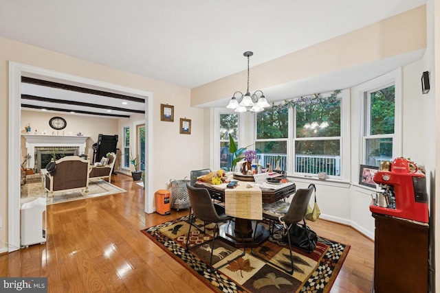 6625 Weatheford Ct, Mclean, VA 22101 - dining room with wood-type flooring, a chandelier, plenty of natural light, and a fireplace