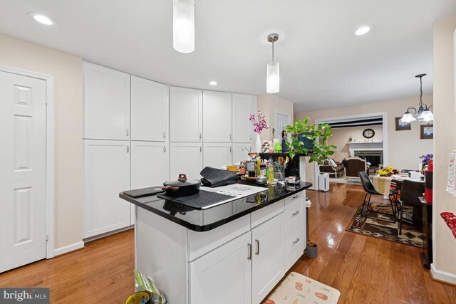 6625 Weatheford Ct, Mclean, VA 22101 - kitchen with light wood-style flooring, white cabinets, hanging light fixtures, and recessed lighting
