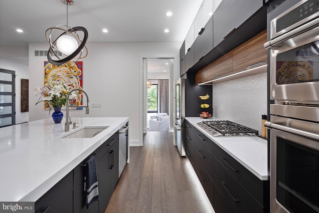 341 Hickman St, Rehoboth Beach, DE 19971 - kitchen featuring a sink, dark cabinetry, appliances with stainless steel finishes, light countertops, and recessed lighting