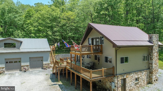 2250 Hoyes Run Rd, Mc Henry, MD 21541 - view of front of home with stone siding, a wooden deck, metal roof, a standing seam roof, and a view of trees
