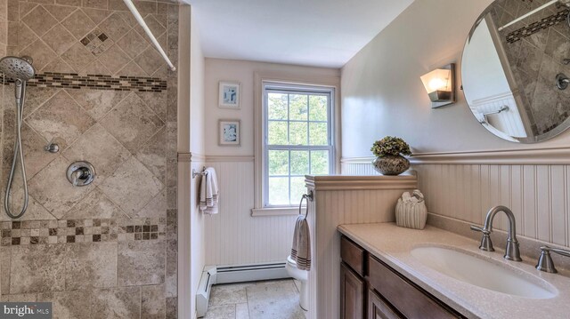 1607 Somers Point Rd, Egg Harbor Twp, NJ 08234 - full bathroom featuring a wainscoted wall, a tile shower, vanity, stone finish floors, and baseboard heating