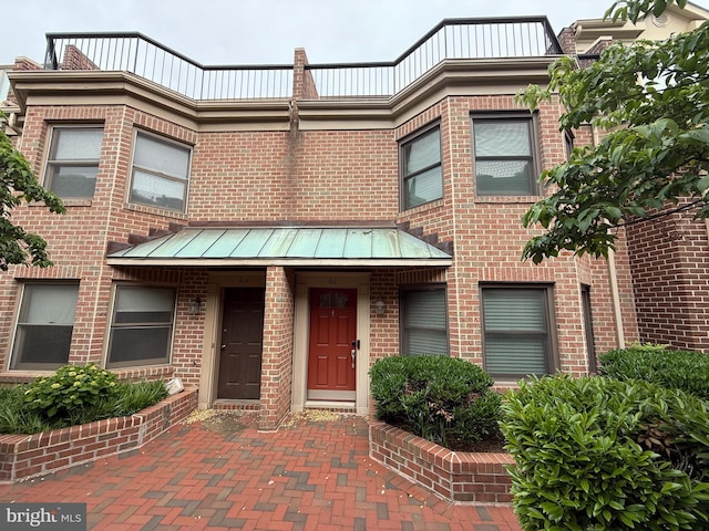 611 N Tazewell St, Arlington, VA 22203 - townhome / multi-family property featuring brick siding, a standing seam roof, and metal roof