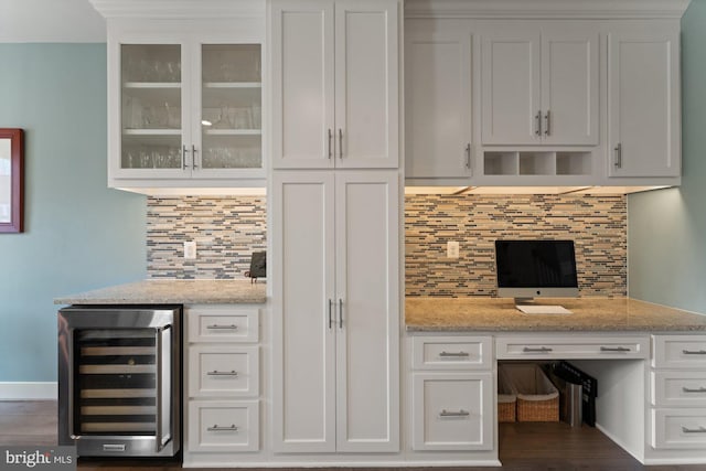 145 Center St S Unit 4, Vienna, VA 22180 - bar area featuring beverage cooler, decorative backsplash, built in desk, and dark wood-style floors
