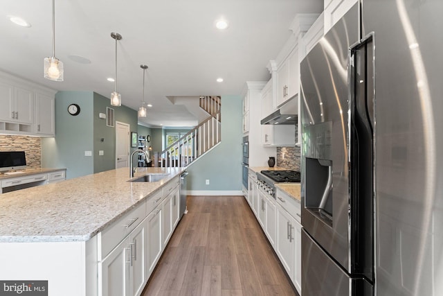 145 Center St S Unit 4, Vienna, VA 22180 - kitchen with appliances with stainless steel finishes, a sink, white cabinets, tasteful backsplash, and wood finished floors