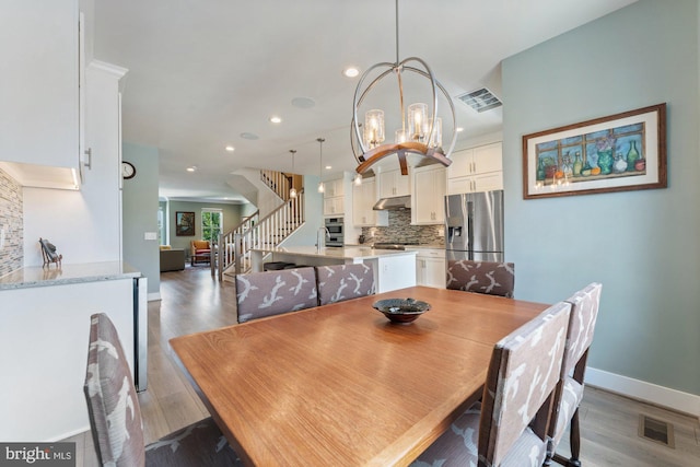 145 Center St S Unit 4, Vienna, VA 22180 - dining space featuring stairway, baseboards, light wood-style floors, recessed lighting, and a chandelier