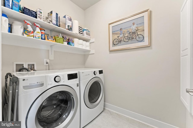 145 Center St S Unit 4, Vienna, VA 22180 - washroom with washing machine and dryer, baseboards, and light tile patterned floors