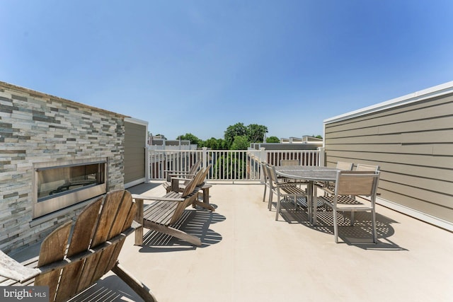 145 Center St S Unit 4, Vienna, VA 22180 - view of patio with a glass covered fireplace and outdoor dining area
