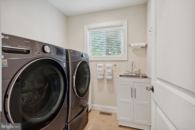1028 Sandpiper Ln, Annapolis, MD 21403 - laundry area with washing machine and clothes dryer, cabinet space, and light tile patterned floors