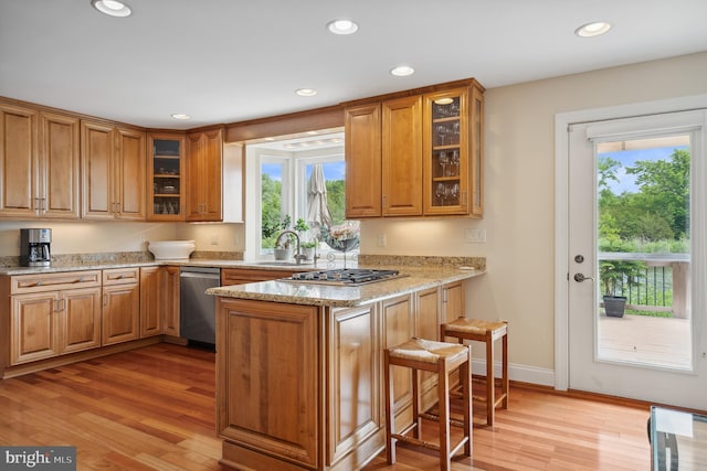 1028 Sandpiper Ln, Annapolis, MD 21403 - kitchen with stainless steel appliances, a peninsula, light wood-style floors, brown cabinetry, and recessed lighting