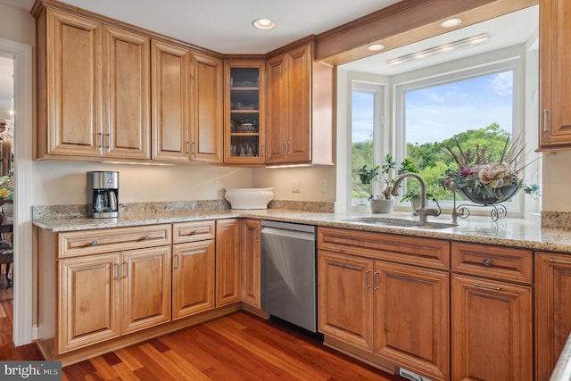 1028 Sandpiper Ln, Annapolis, MD 21403 - kitchen with stainless steel dishwasher, wood finished floors, brown cabinets, light stone countertops, and glass insert cabinets