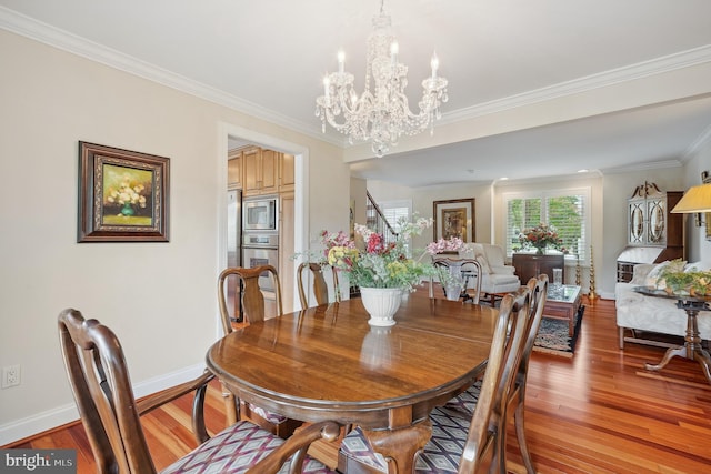 1028 Sandpiper Ln, Annapolis, MD 21403 - dining area with a chandelier, light wood-type flooring, and crown molding