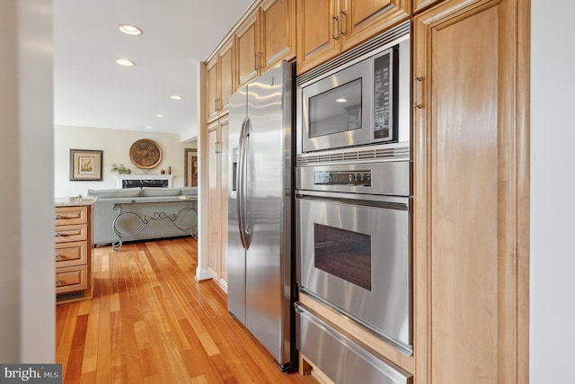 1028 Sandpiper Ln, Annapolis, MD 21403 - kitchen with appliances with stainless steel finishes, a warming drawer, light wood-style floors, recessed lighting, and open floor plan