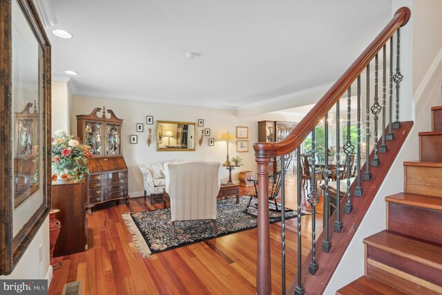 1028 Sandpiper Ln, Annapolis, MD 21403 - stairs featuring ornamental molding, wood finished floors, and recessed lighting