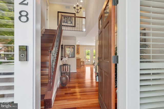 1028 Sandpiper Ln, Annapolis, MD 21403 - entrance foyer featuring stairway, light wood-style flooring, a high ceiling, crown molding, and a chandelier